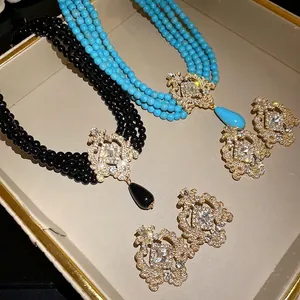 Elegant vintage multilayer beaded necklace and earring set with ornate teardrop pendants