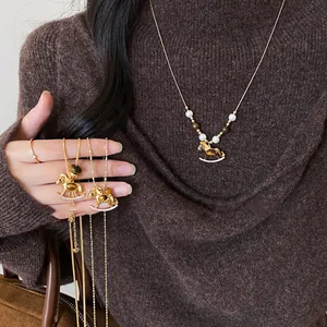Close-up detail of a vintage style rocking horse necklace with tiger eye stone and zircons.