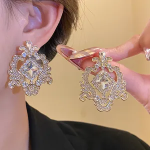 Close-up of elegant vintage-style chandelier earrings featuring sparkling clear crystals