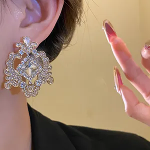 Detail shot of vintage court-style earring with large square crystal and rhinestones.