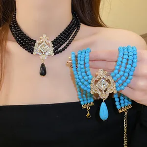 Detailed view of vintage multi-layer beaded choker necklace with ornate teardrop pendant