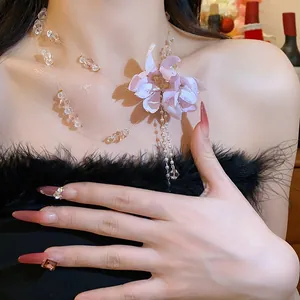 Close-up of elegant fabric flower necklace with pearl tassels and crystal beads