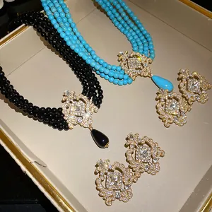 Detail view of luxury vintage palace style beaded necklaces and matching earrings