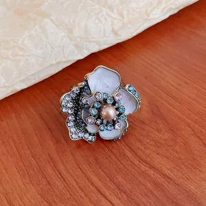 Macro view of vintage floral earring with elegant blue rhinestones and center pearl detail