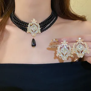 Detail view of vintage court style jewelry set with black beads and teardrop pendant