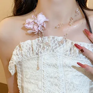 Detailed shot of elegant fabric flower necklace with crystal beads and long tassels