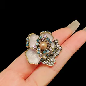 Detailed macro view of vintage flower earrings with white enamel petals and pearl center
