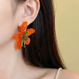 Vintage orange flower earrings with crystals and acetate petals on silver needles.