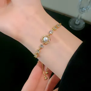 Detailed view of elegant gold-plated bracelet featuring pearl and sparkling zircons