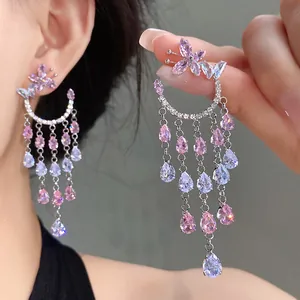 Close-up detail of luxury zircon butterfly earrings with pink waterdrop tassel fringe
