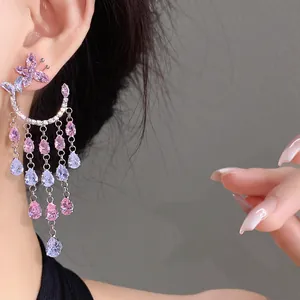 Elegant close-up of purple zircon butterfly tassel earrings with dangling teardrop stones