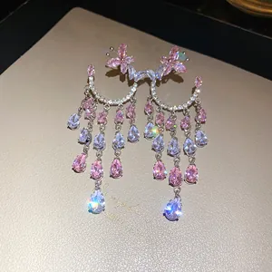 Detail view of luxury pink zircon butterfly earrings with sparkling water drop tassels