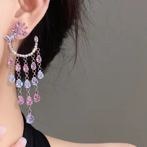 Close-up detail of silver needle zircon butterfly earrings with cascading waterdrop tassels