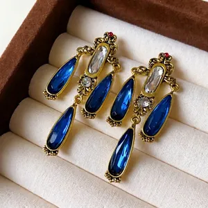 Vintage antique gold tassel drop earrings with blue teardrop crystals and clear stones