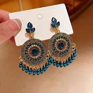 Vintage ethnic style gold earrings with blue rhinestones and blue beaded tassels for women