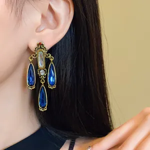 Detailed view of vintage court style blue water drop tassel earrings worn by a model