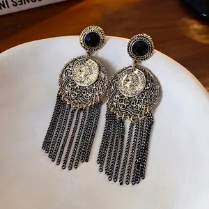 Vintage-style hollow tassel earrings featuring gold coins and black stone accents