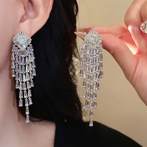 Elegant gold-plated zircon tassel earrings worn by a model to show drape and sparkle.