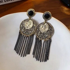 Vintage-style hollow round earrings with long black chain tassels and coin detail.