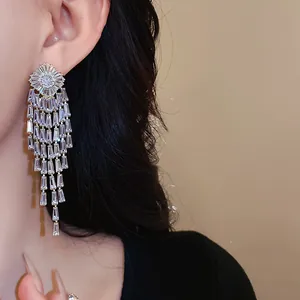 Elegant close-up view of silver-plated long zircon tassel drop earrings on a model