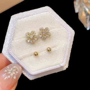 Exquisite zircon flower stud earrings and simple ball studs set in a white velvet box.