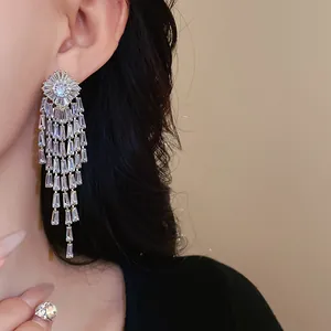 A highly detailed close-up of luxury zircon tassel earrings worn for formal occasions