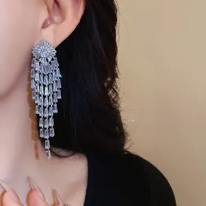 Detail view of sparkling long tassel earrings with baguette-cut cubic zirconia stones