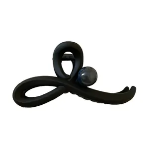 Elegant matte black minimalist hair claw clip with a decorative blue marble bead.