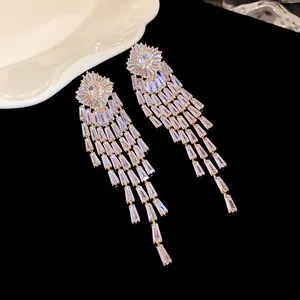 Close-up of elegant gold plated tassel earrings with sparkling cubic zirconia stones