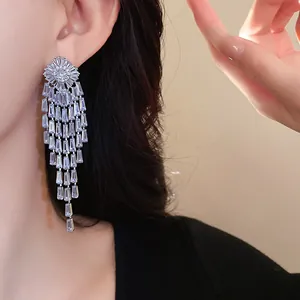 Detail of luxurious gold plated zirconia tassel earrings showing sparkle and movement