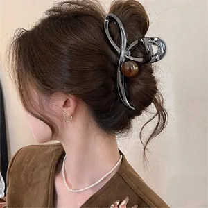 Large elegant vintage coffee brown bow hair claw clip with amber bead shown on model