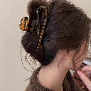 Detail of vintage tortoise shell hair claw clip in an elegant bun hairstyle