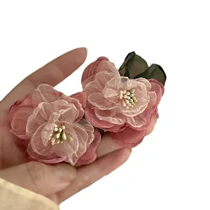 Elegant pink fabric flower earrings with layered petals and silver needles for women