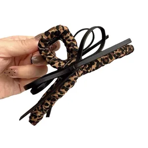 Vintage leopard print hair claw clip with black leather bow accent for thick hair