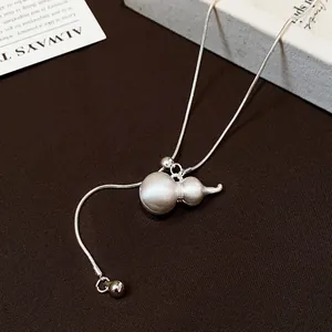 Detailed macro view of a brushed silver hulu gourd pendant on an adjustable slider chain