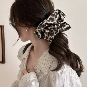 Detailed shot showing the texture of a vintage leopard print hair scrunchie for ponytails