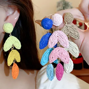 Handmade colorful raffia woven drop earrings featuring vibrant dopamine style colors.