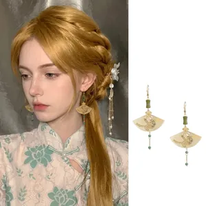Boucles d'oreilles élégantes de style chinois traditionnel portées par un modèle