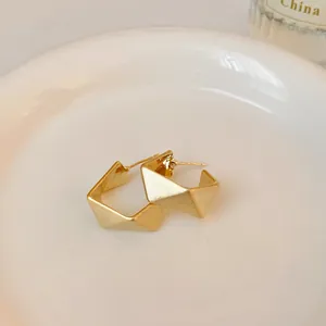 Close-up detail of modern matte gold geometric square hoop earrings for daily wear