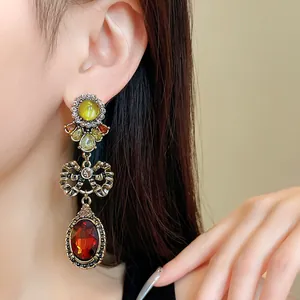 Vintage bow-shaped tiered earrings with large amber faceted stone details