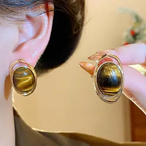 Vintage style gold-plated tiger-eye resin stud earrings with minimalist oval design