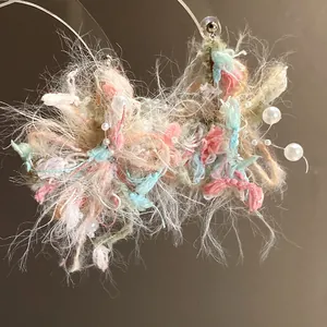 Primer plano de pendientes de flores de hilo suave hechos a mano con detalles de perlas