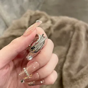 Detailed view of elegant multi-layer crisscross zircon open ring in silver finish