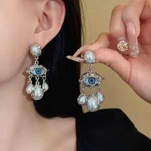 Retro palace style eye drop earrings with pleated silver texture and faux pearls