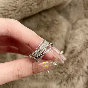 Close-up detail of silver crisscross multi-layer ring set with sparkling zircons