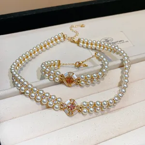 Detail view of 18k gold plated zircon pearl necklace and bracelet set in jewelry box