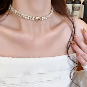 Elegant double-strand pearl choker with 18k gold-plated zircon buckle worn by model