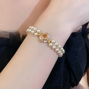 Close-up detail of double-strand pearl bracelet with 18k gold plated zircon centerpiece