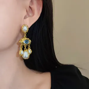 Elegant vintage style evil eye earrings featuring artificial pearl tassels in a gold-tone finish