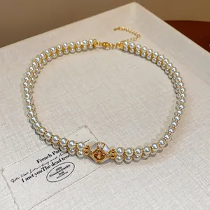 Close-up view of elegant 18k gold plated double strand pearl necklace with a zircon centerpiece
